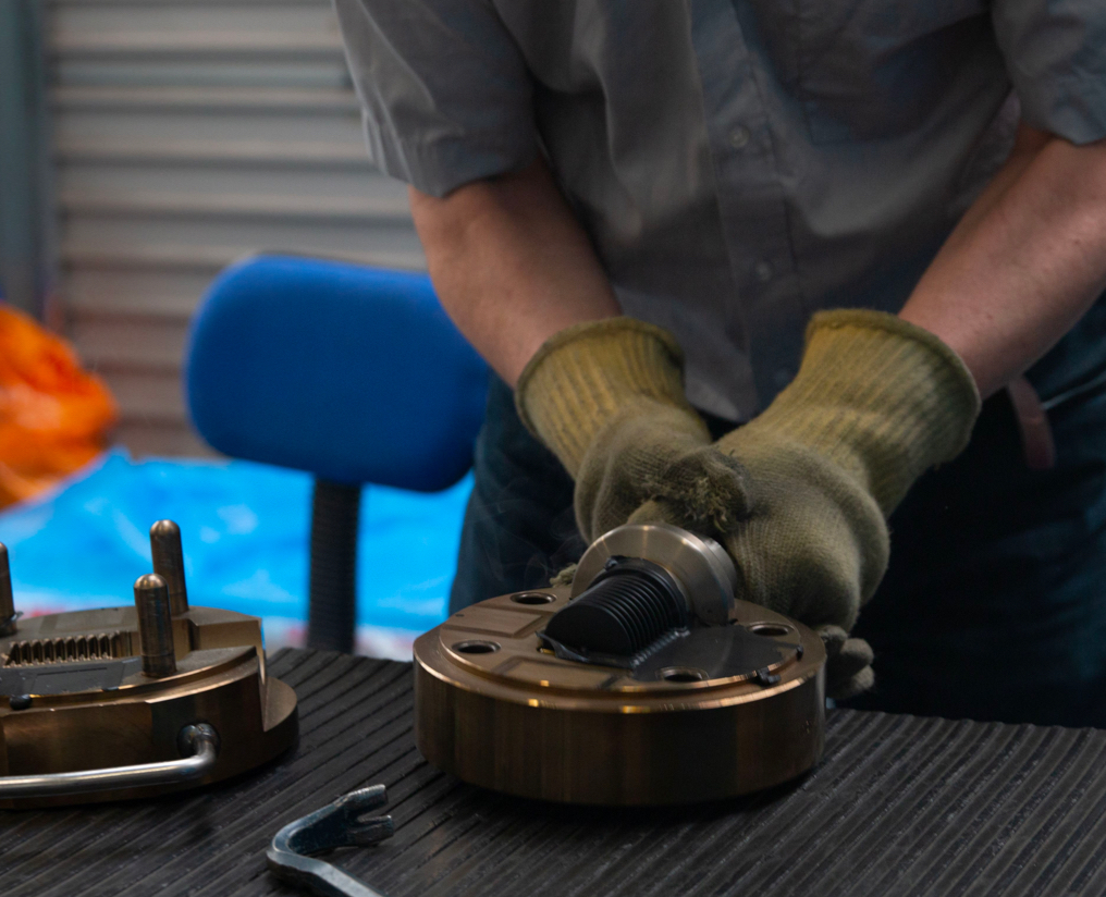 An engineer removing a motorsport component from a mold.